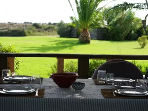 Table set for dinner on the porch overlooking the garden at Villa Almar in Tarifa