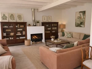 Bright living room with sofas, bookcases and a fireplace at Villa Almar in Tarifa