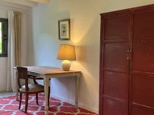 Writing desk with lamp next to an antique red wardrobe at Villa Almar in Tarifa