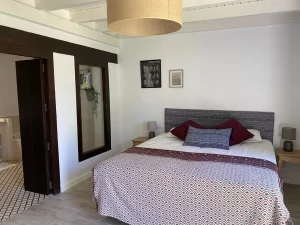 Double bedroom with a sliding door to the en-suite bathroom at Villa Almar in Tarifa