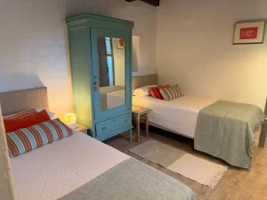 Twin room with a painted vintage wardrobe at Villa Almar in Tarifa