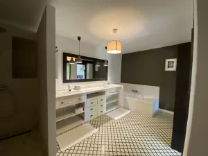 Bathroom with double sink and bathtub on patterned floor tiles at Villa Almar in Tarifa