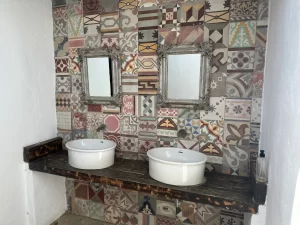 Twin vessel washbasins against colourful hydraulic tiles at Villa Almar in Tarifa