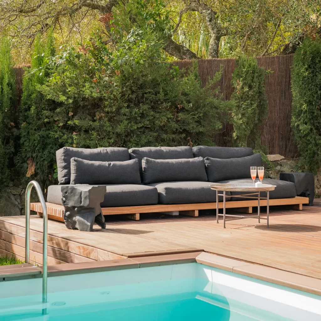 Pool deck lounge with dark grey outdoor sofa at La Casita Paraiso in Tarifa