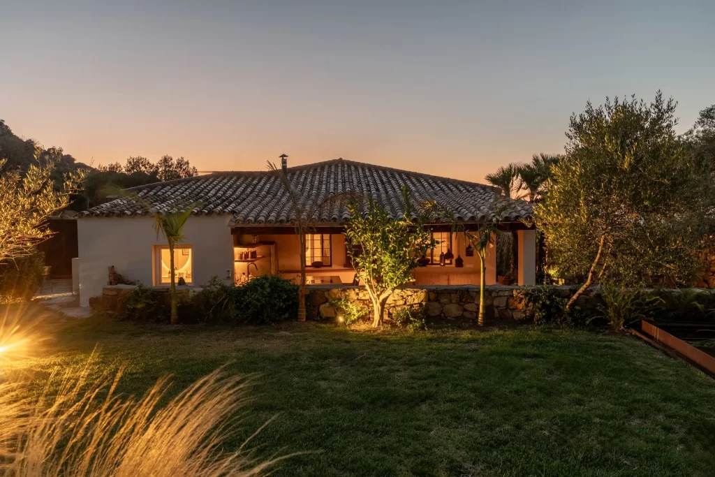 Villa Gran Paraiso rear facade illuminated at dusk with garden