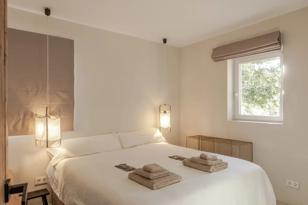 Bedroom at Villa Gran Paraiso with hanging fabric pendant lights and garden view
