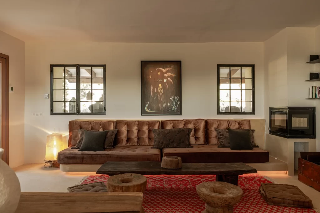 Living room at Villa Gran Paraiso with tufted velvet sofa and iron-framed windows
