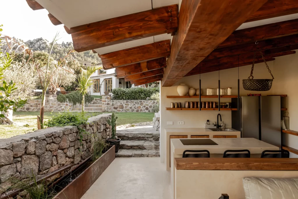 Outdoor kitchen counter at Villa Gran Paraiso with stone wall water feature and mountain view