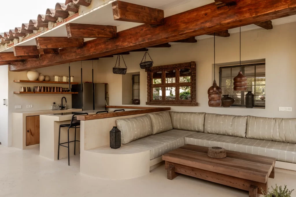 Outdoor kitchen and lounge at Villa Gran Paraiso with carved wooden mirror and pendant lamps